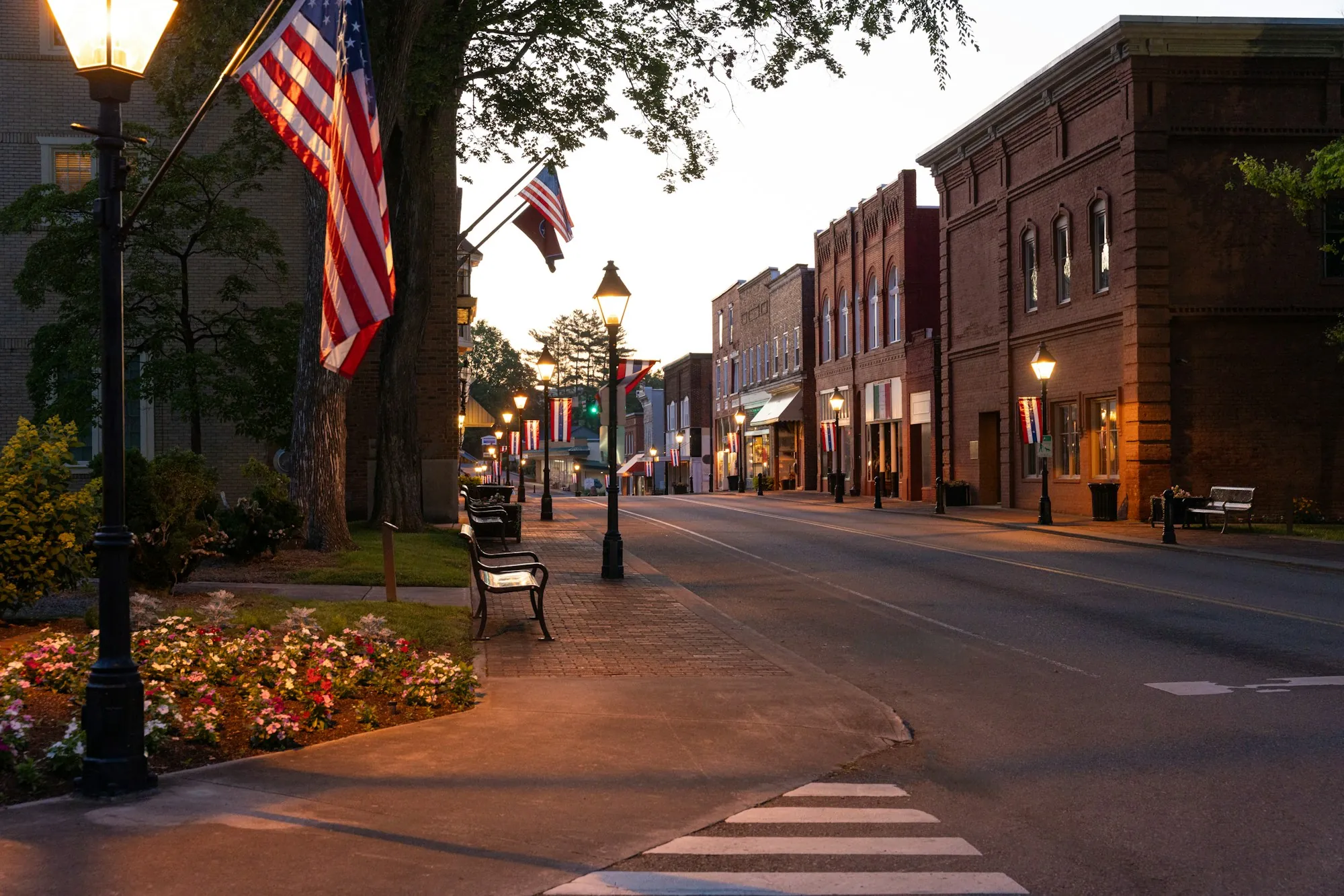 Main street storefronts and sidewalks at dusk