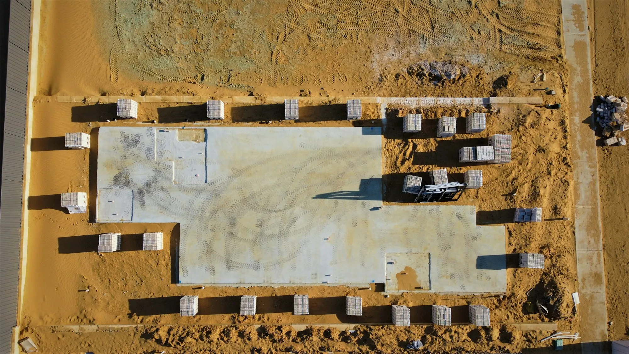 Aerial view of slab forms set on a graded lot