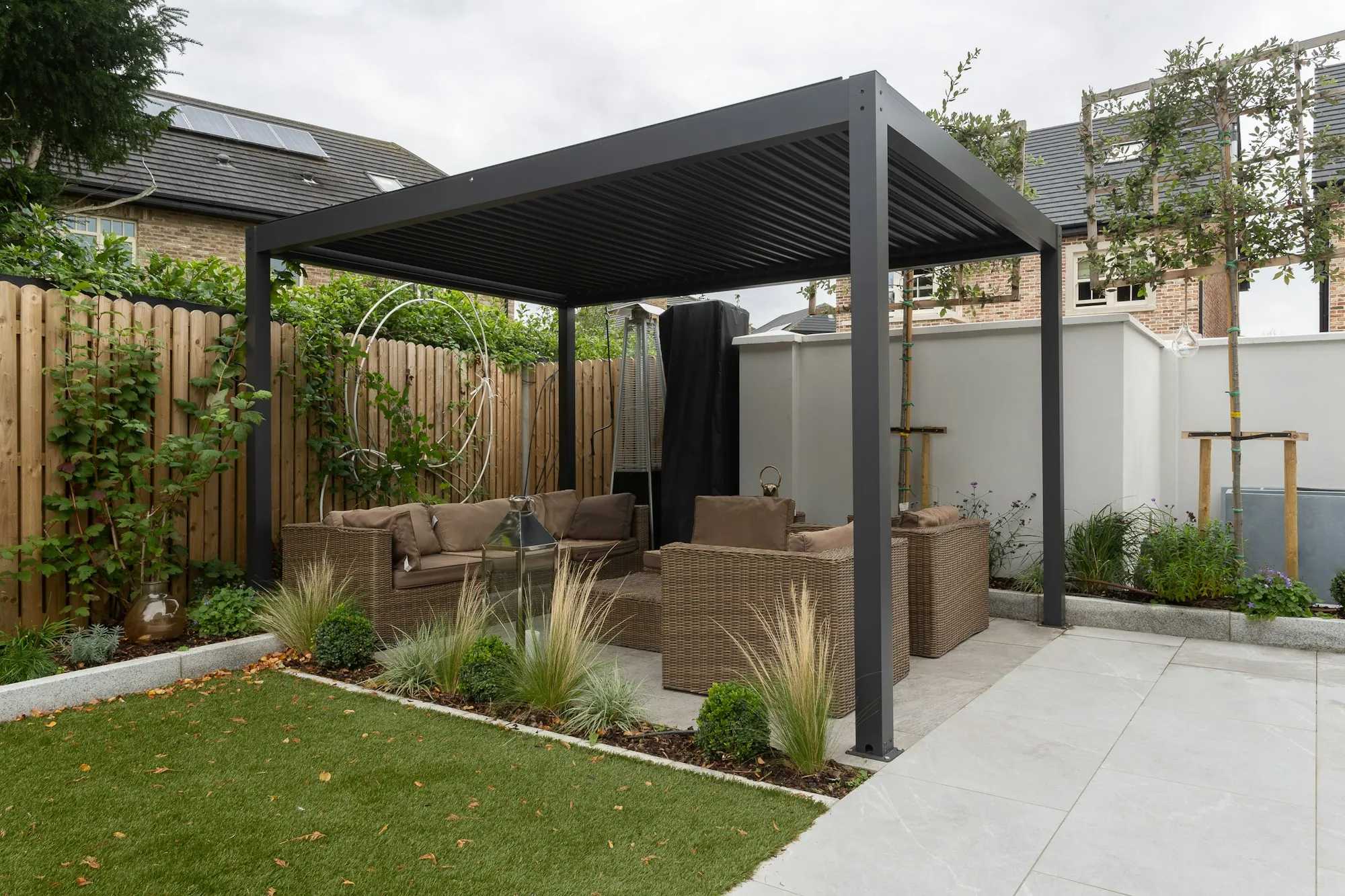 Concrete patio and walkway under a modern pergola